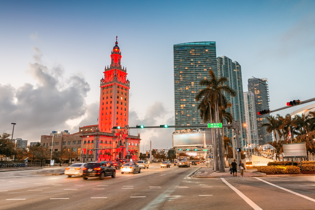 Freedom Tower at dusk with downtown Miami luxury condos in the background, symbolizing the real estate market where bridge loan costs come into play.